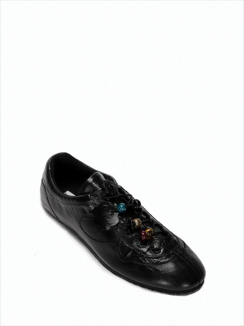 Pointed Toe Black Cowhide Flats with Floral Appliqués