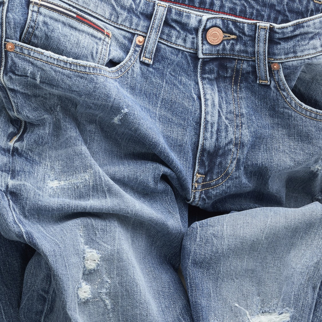 Faded Blue Denim Jeans with Distressed Detailing