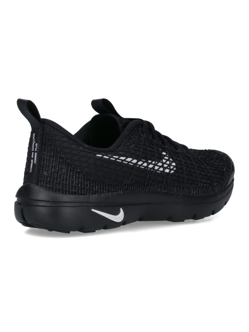 Textured Black Sneakers With Low-Profile Design And Distinctive Branding