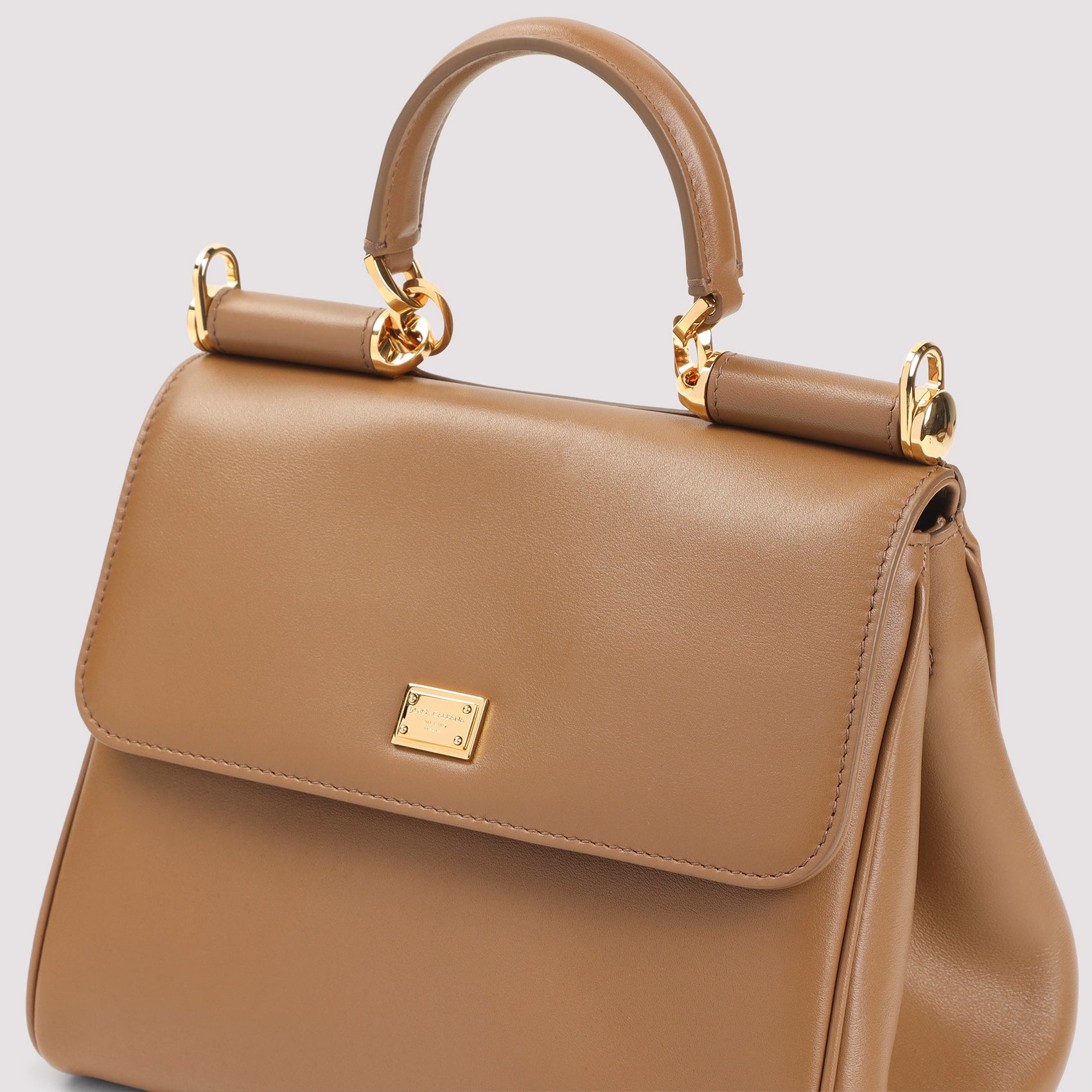 Compact Brown Leather Handbag with Gold Accents