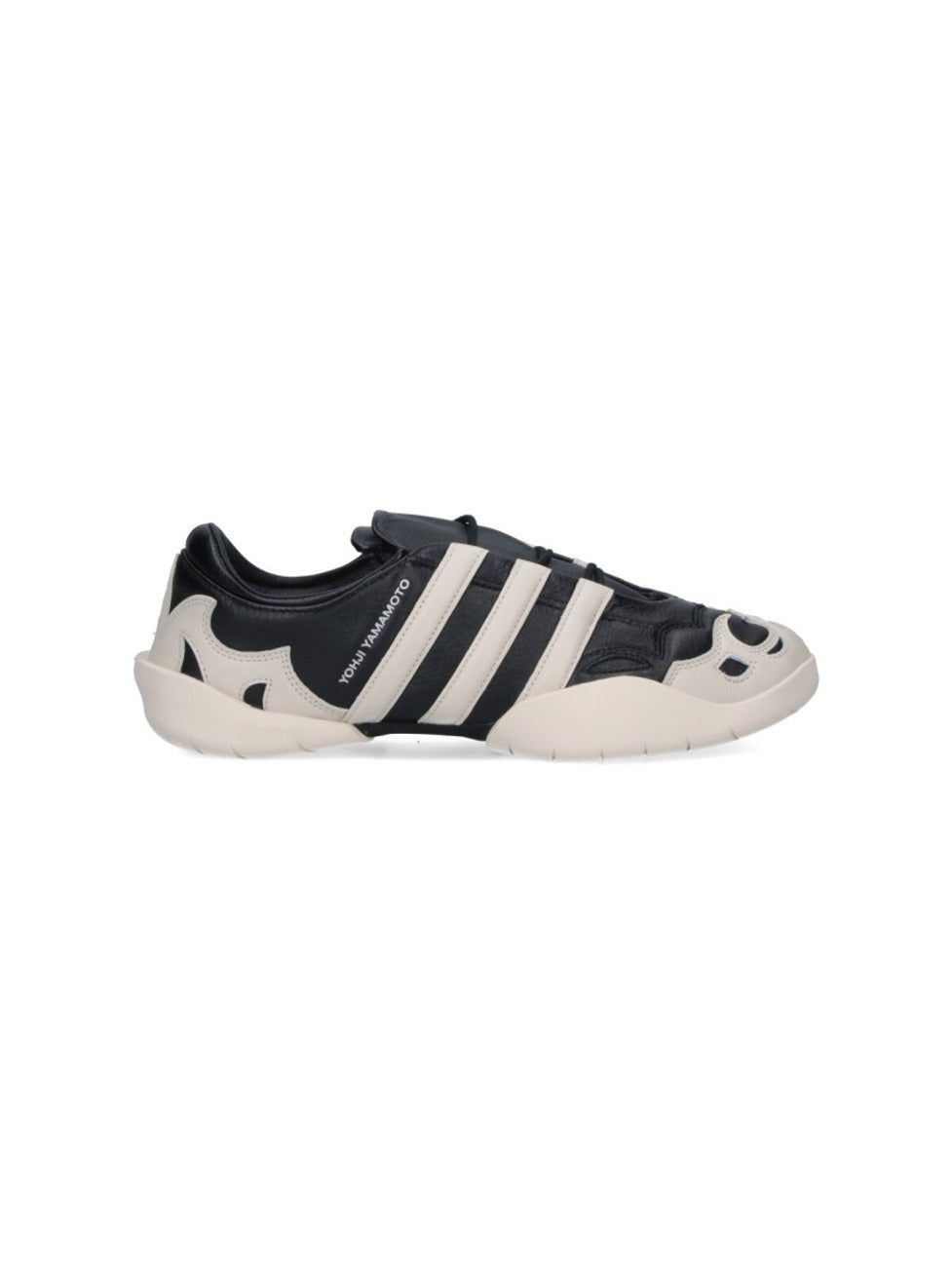 Black Leather Sneakers With Cream Accents And Iconic Stripes
