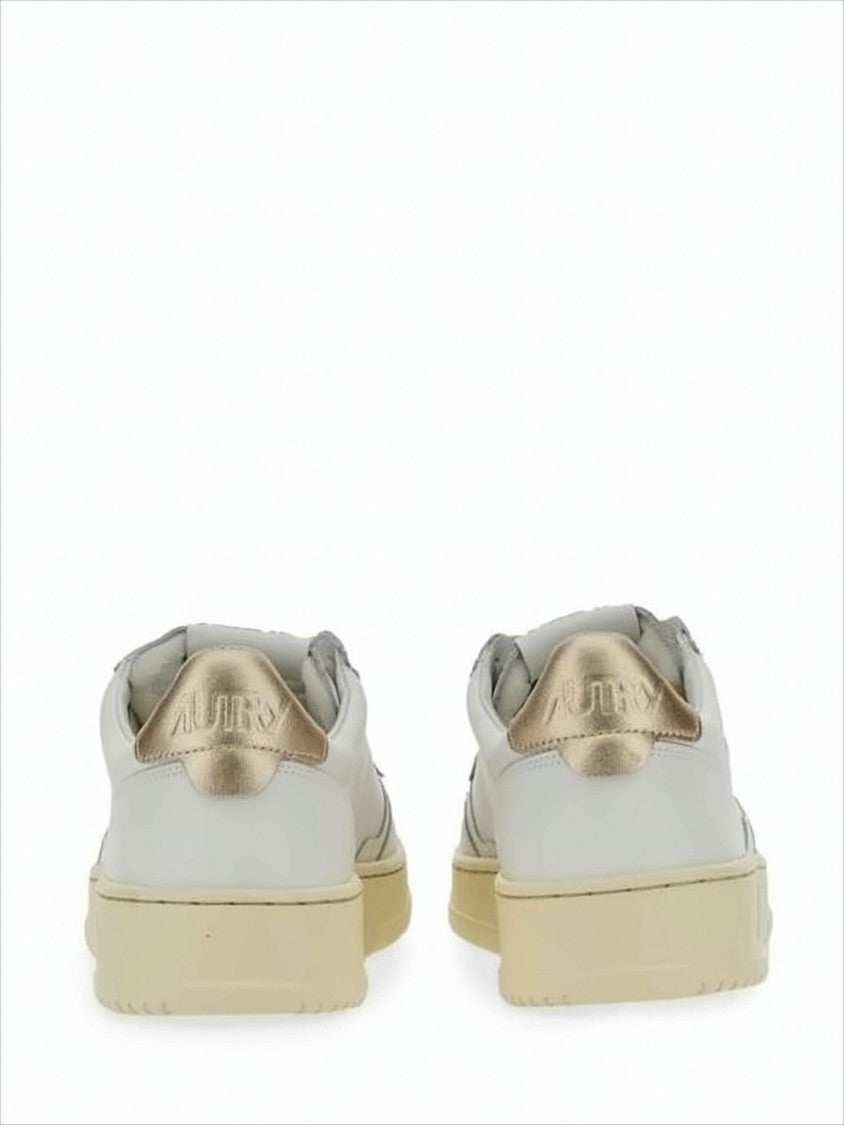 Low-Top White Sneakers with Perforated Detailing and Metallic Accents