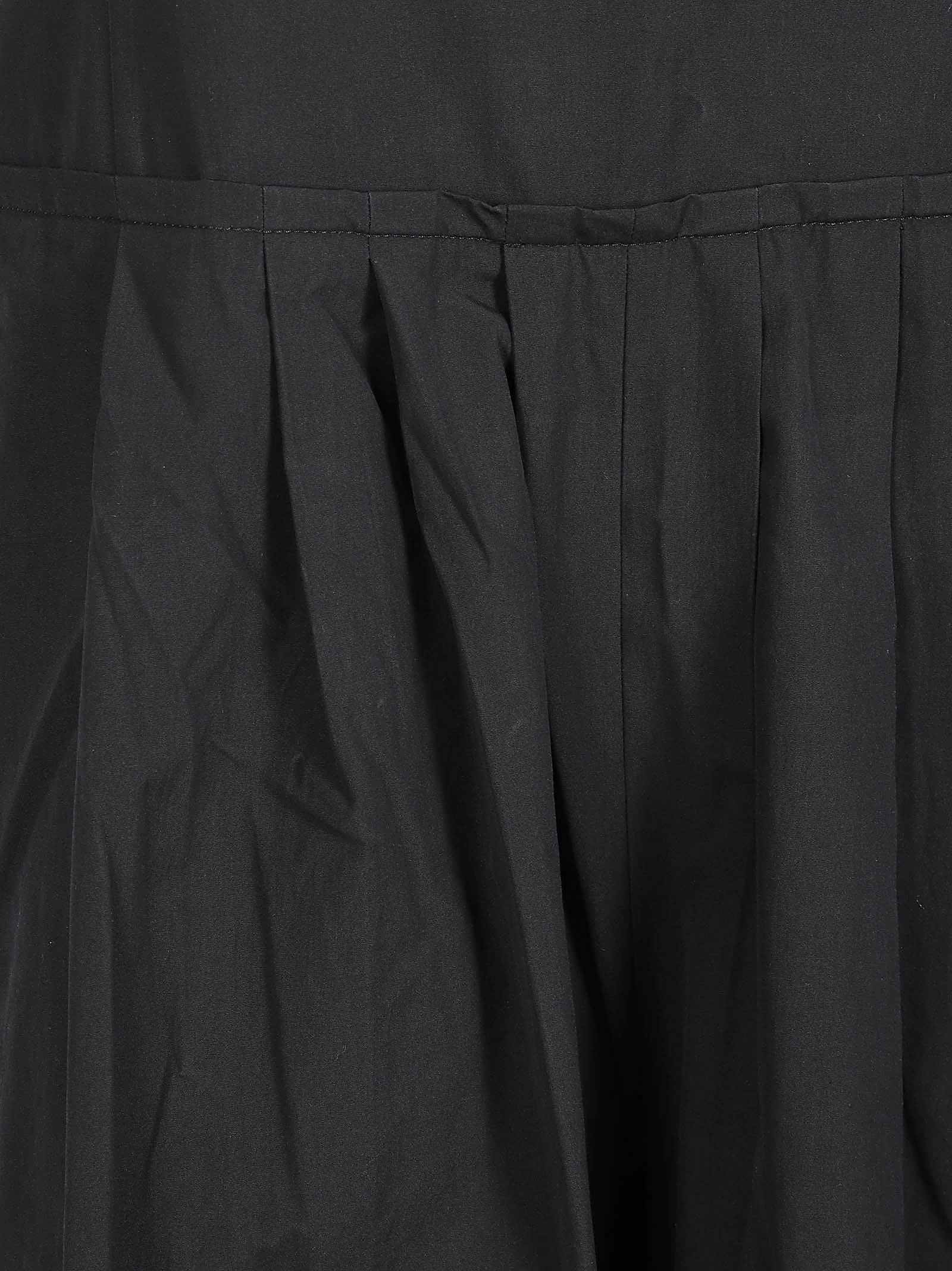 Sleeveless Black Dress with Tie Straps and Pleated Skirt