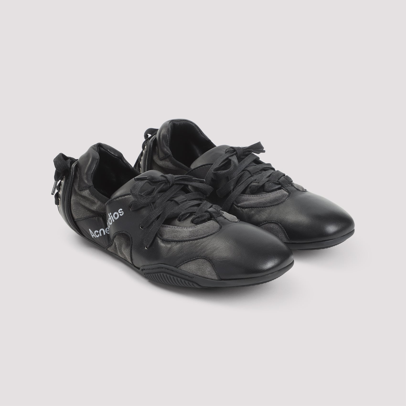Low-Profile Black Sneakers with Distinctive Logo