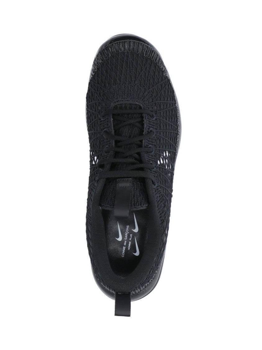 Textured Black Sneakers With Low-Profile Design And Distinctive Branding