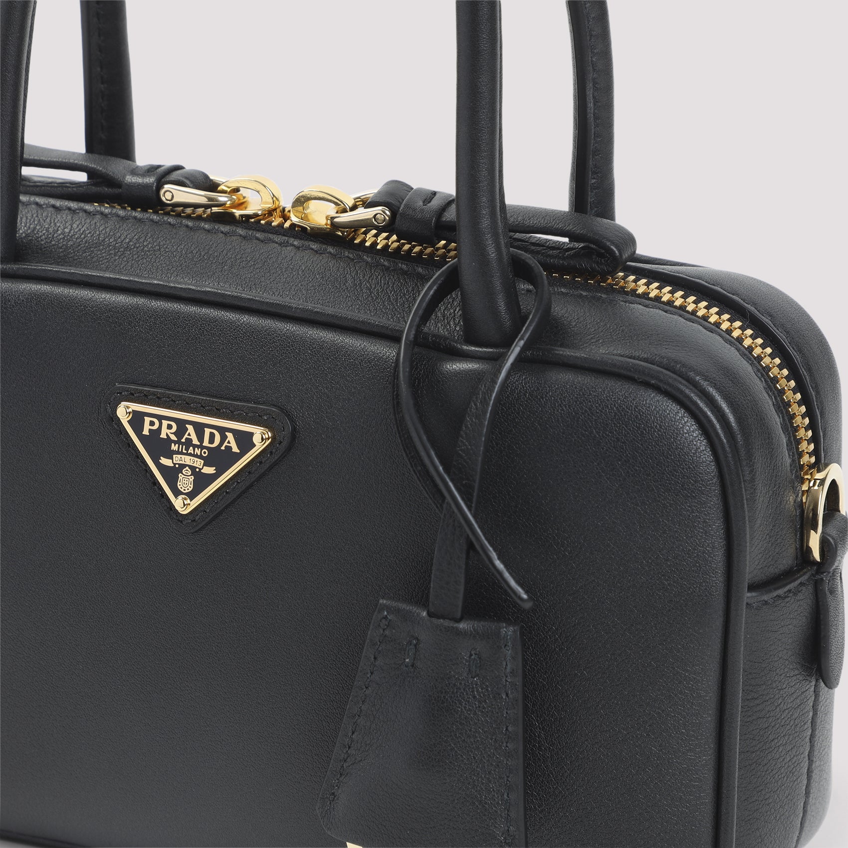 Compact Black Calf Leather Handbag with Gold Accents