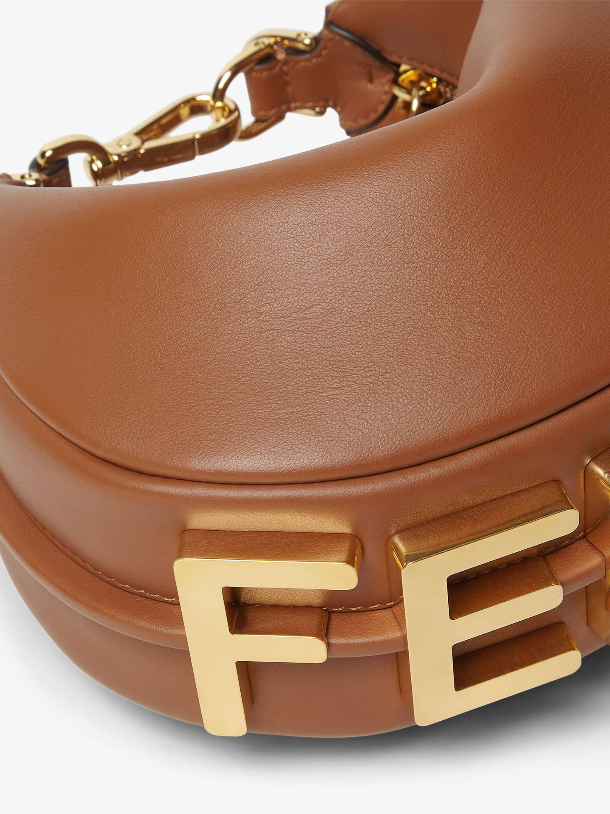 Crescent-Shaped Leather Handbag with Polished Finish and Bold Letter Embellishments